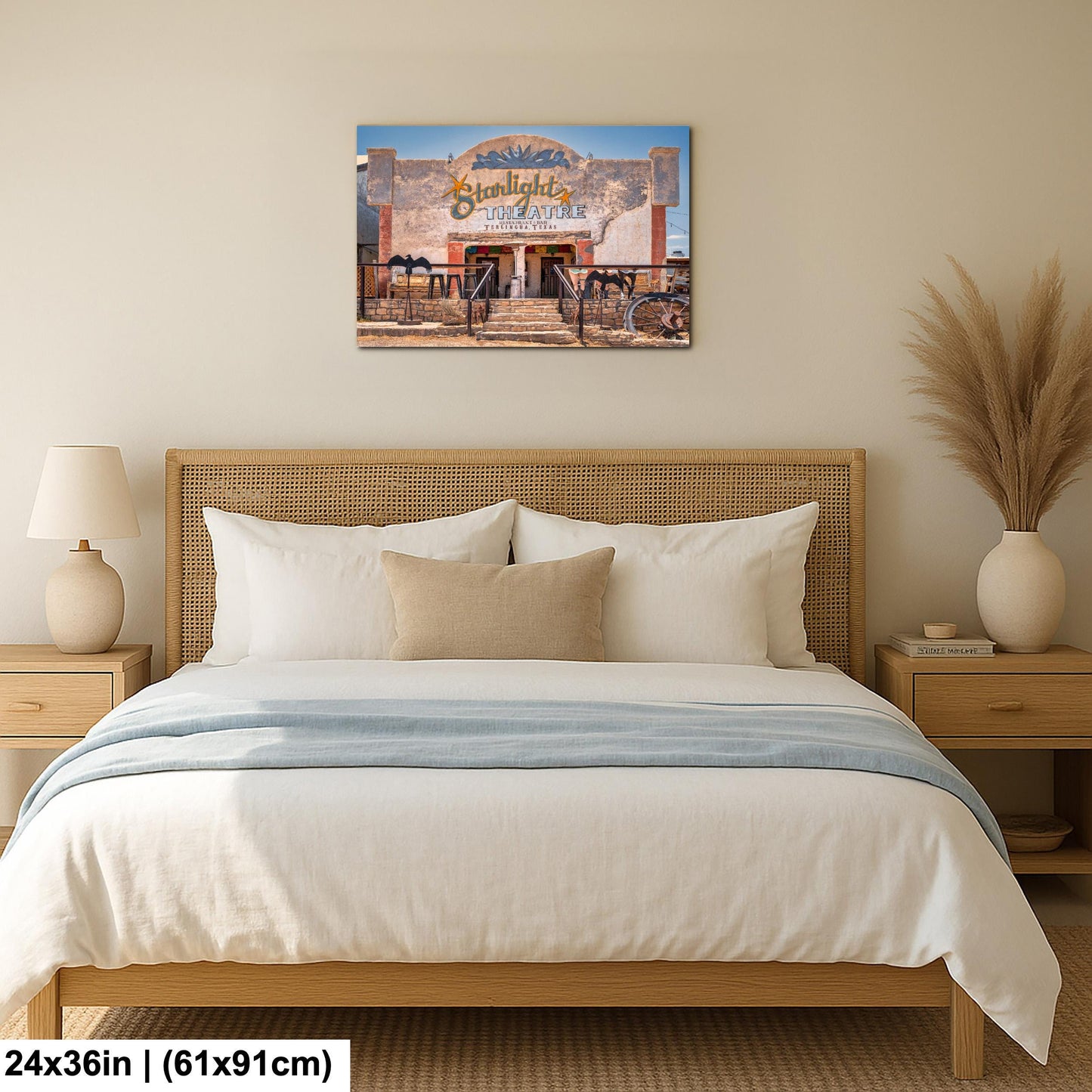 a bedroom with a large bed, a nightstand, and a lamp. Above the bed, there is a framed picture of a building with a sign that reads "Sunlight Restaurant".